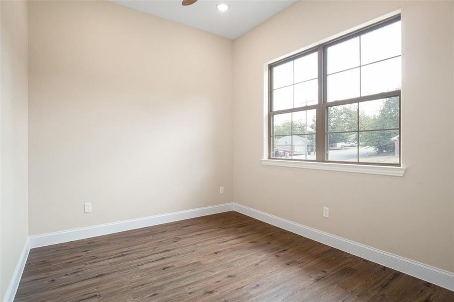 Spare room featuring ceiling fan and hardwood / wood-style floors