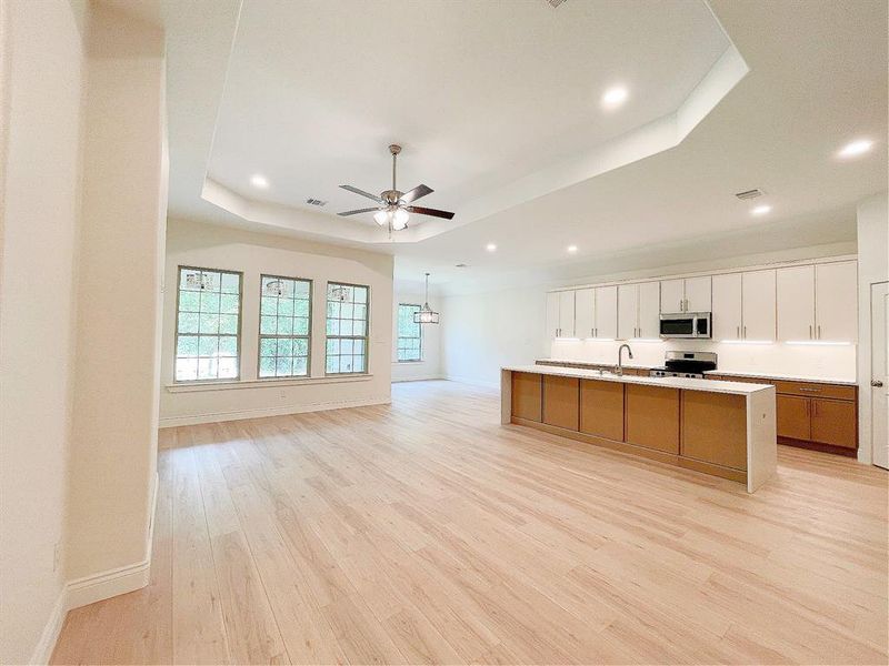 Modern Kitchen with two-toned cabinets, trayed ceiling to separate family room from kitchen