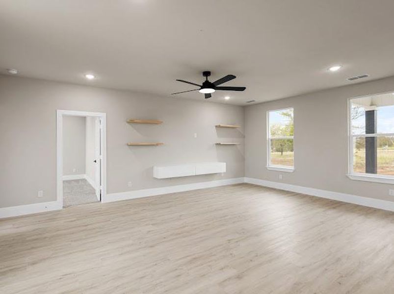 Unfurnished living room featuring light wood-style floors, a ceiling fan, and recessed lighting