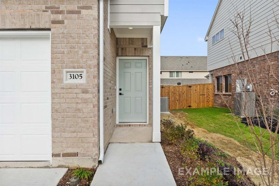 Property entrance featuring a yard and central AC