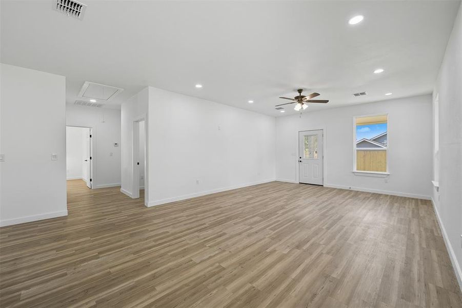 Unfurnished room with attic access, recessed lighting, light wood finished floors, and a ceiling fan Unfurnished room with attic access, recessed lighting, light wood finished floors, and a ceiling fan
