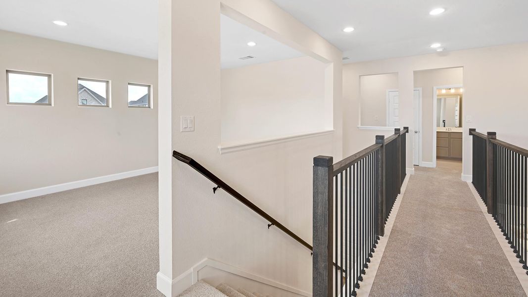Hall featuring light colored carpet, an upstairs landing, and recessed lighting