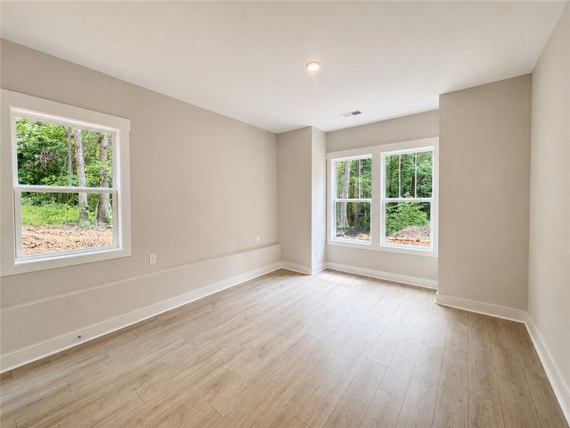 A quiet space with light flooring and tall windows