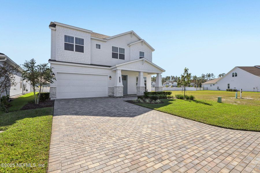 Front exterior of a new home in Courtney Chase, St. Augustine, FL, highlighting curb appeal (Image 25). Front exterior of a new home in Courtney Chase, St. Augustine, FL, highlighting curb appeal (Image 25).