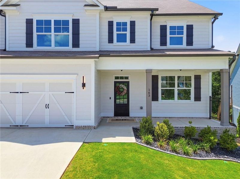 Front exterior of a new home in , Woodstock, GA, highlighting curb appeal (Image 26). Front exterior of a new home in , Woodstock, GA, highlighting curb appeal (Image 26).