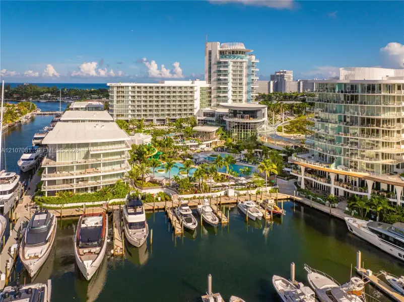 Waterfront complex featuring deep-water boat slips, a swimming pool, and tropical landscaping Waterfront complex featuring deep-water boat slips, a swimming pool, and tropical landscaping
