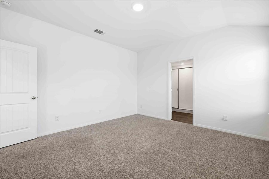 The primary suite is set apart with backyard views, soft carpeting, and a private ensuite bath. The primary suite is set apart with backyard views, soft carpeting, and a private ensuite bath.