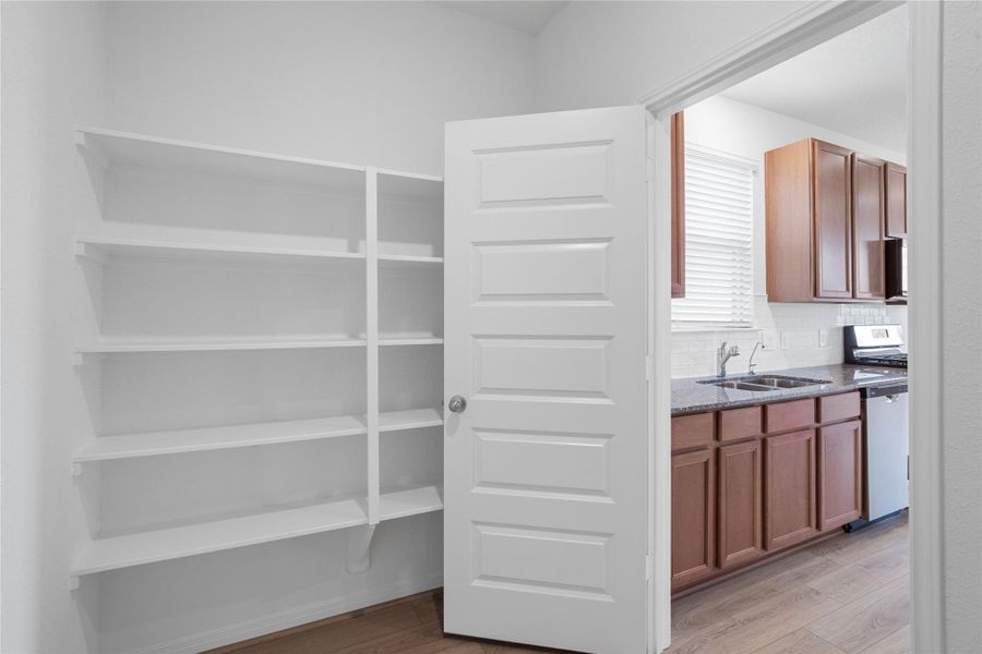 Enjoy an exceptionally organized kitchen with the pantry providing extensive shelving and storage solutions.