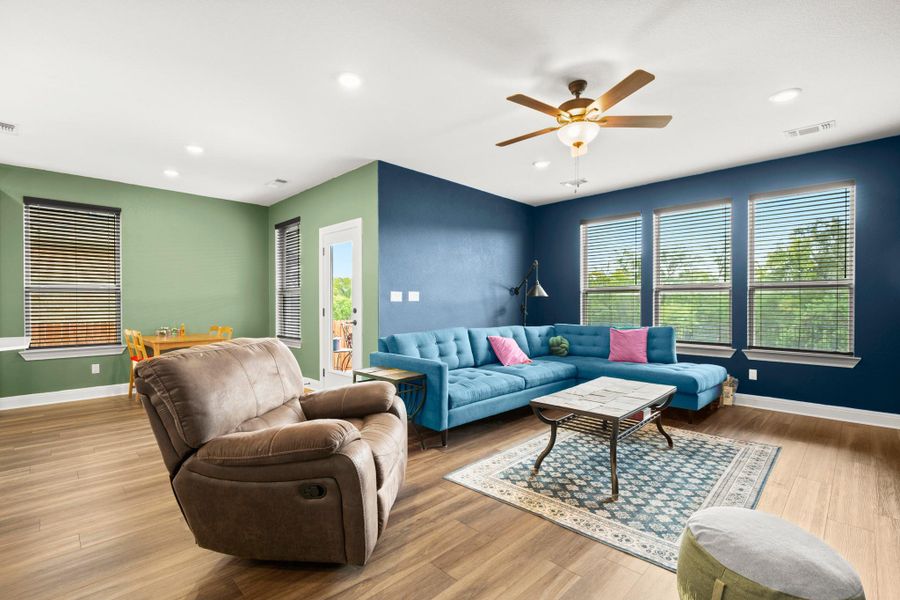Living room featuring light wood finished floors, recessed lighting, and ceiling fan Living room featuring light wood finished floors, recessed lighting, and ceiling fan