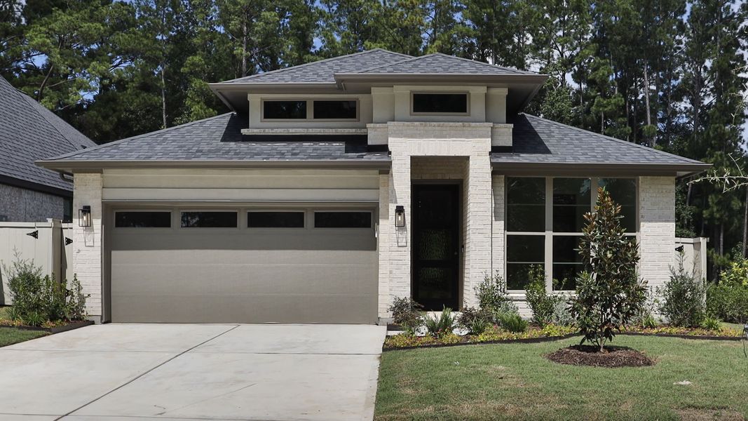 Front exterior of a new home in Audubon, Magnolia, TX, highlighting curb appeal (Image 1). Front exterior of a new home in Audubon, Magnolia, TX, highlighting curb appeal (Image 1).