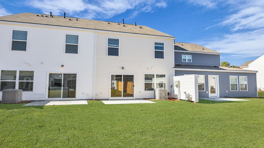 Exterior details and patio area of a home in Pine Hills Townhomes at Cane Bay, Summerville (Image 23). Exterior details and patio area of a home in Pine Hills Townhomes at Cane Bay, Summerville (Image 23).
