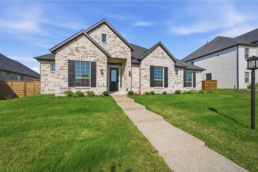 Front exterior of a new home in Solterra, Mesquite, TX, highlighting curb appeal (Image 2). Front exterior of a new home in Solterra, Mesquite, TX, highlighting curb appeal (Image 2).