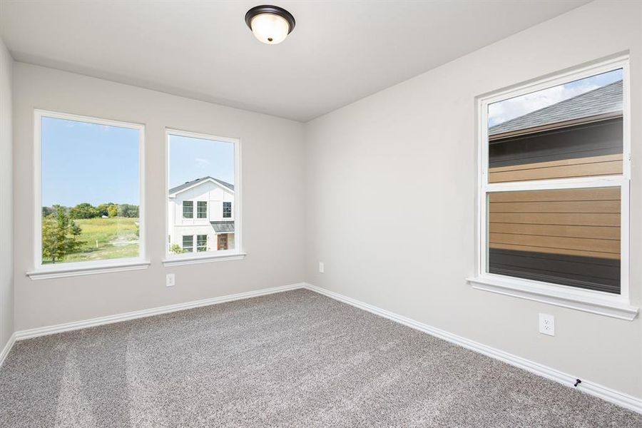 Spare room with baseboards and carpet