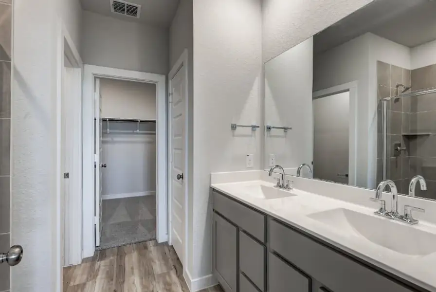 A bathroom with a sink and a shower.