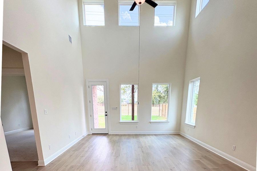 Towering ceilings and clean-lined wood flooring anchor this sun-drenched living space. Towering ceilings and clean-lined wood flooring anchor this sun-drenched living space.