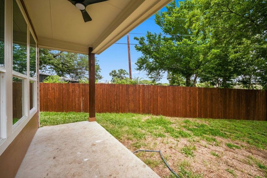 Covered patio featuring a ceiling fan and concrete flooring Covered patio featuring a ceiling fan and concrete flooring