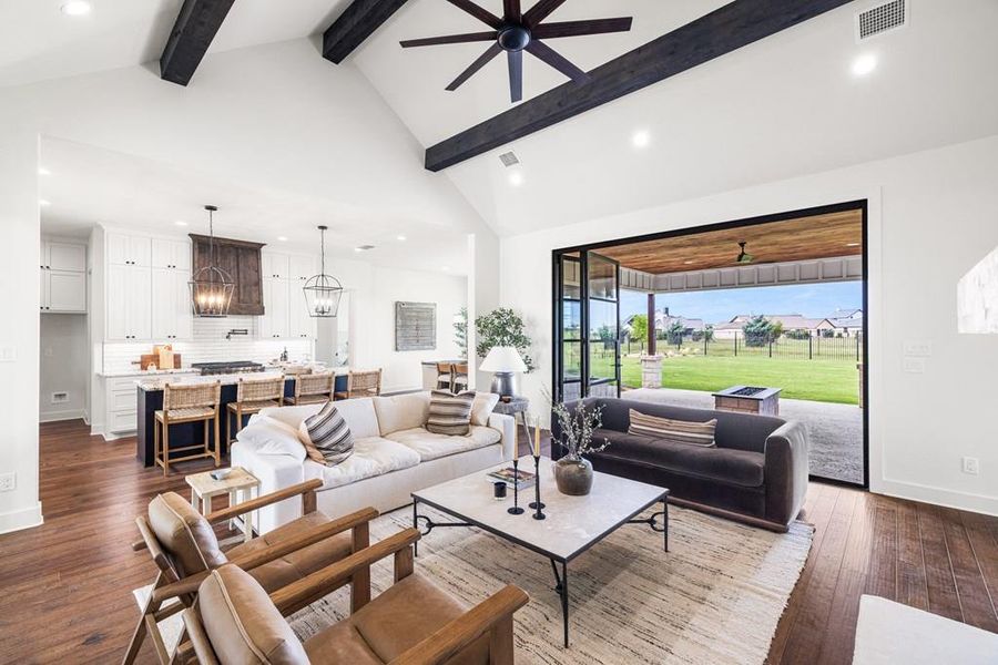 Virtually staged Living area with ceiling fan, recessed lighting, dark engineered wood floors, high vaulted ceiling, and beam ceiling Virtually staged Living area with ceiling fan, recessed lighting, dark engineered wood floors, high vaulted ceiling, and beam ceiling
