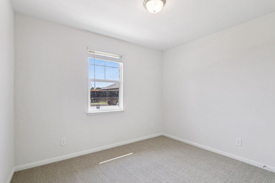 Empty room featuring carpet and baseboards Empty room featuring carpet and baseboards