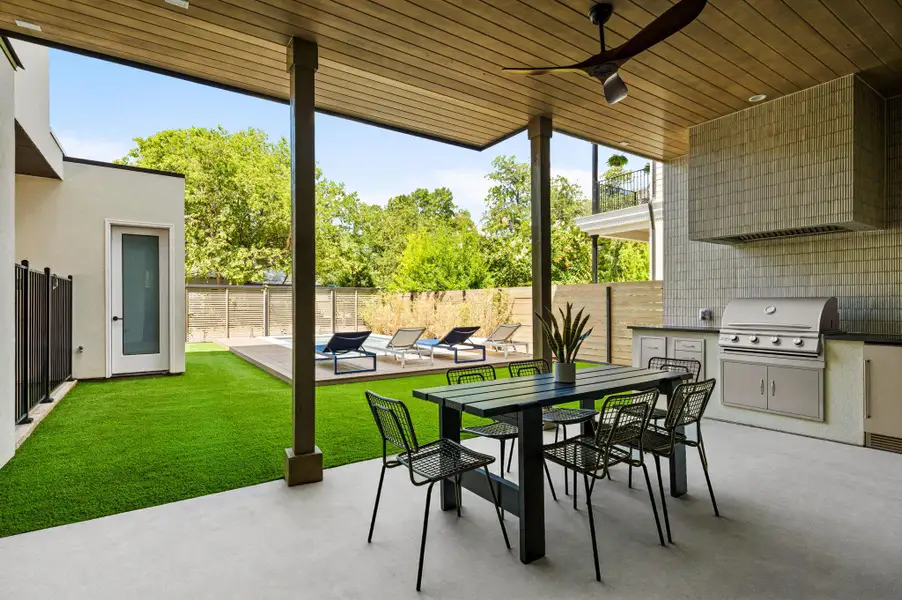 A spacious covered patio features a built-in outdoor kitchen overlooking a private pool and yard. A spacious covered patio features a built-in outdoor kitchen overlooking a private pool and yard.