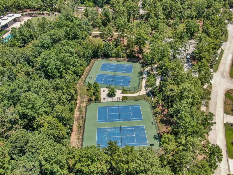 Community tennis courts surrounded by scenic natural beauty.