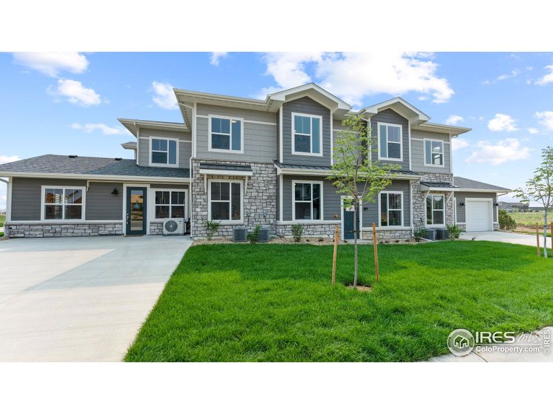 Front exterior of a new home in The Lakes at Centerra - Discovery, Loveland, CO, highlighting curb appeal (Image 2).