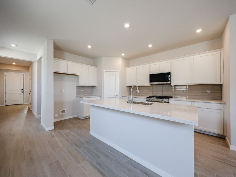 A kitchen with white cabinets.