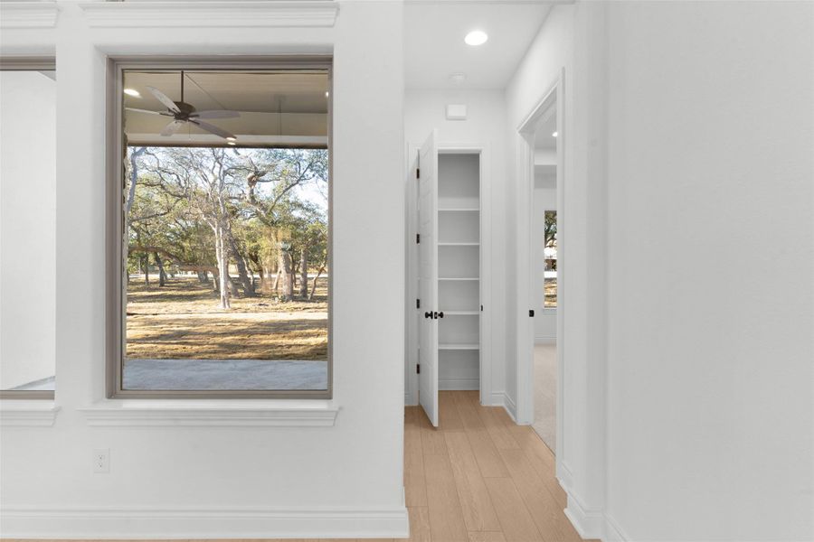 Corridor featuring light wood-type flooring and recessed lighting
