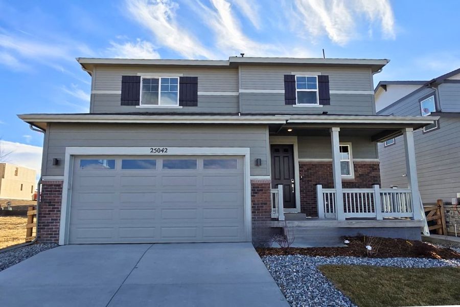 Front exterior of a new home in The Aurora Highlands, Aurora, CO, highlighting curb appeal (Image 1). Front exterior of a new home in The Aurora Highlands, Aurora, CO, highlighting curb appeal (Image 1).