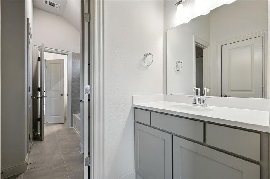 Bathroom featuring vanity and light tile patterned floors