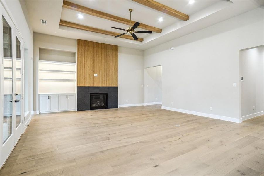 Fireplace wall has trendy natural wood stained slat wall accented with black tile for a dramatic look! Fireplace wall has trendy natural wood stained slat wall accented with black tile for a dramatic look!