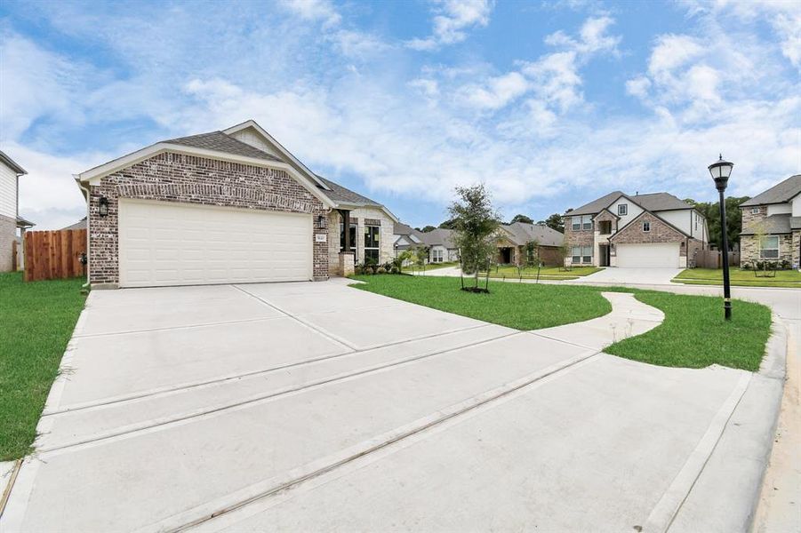 The residence features a practical 2-car garage complemented by a generous driveway, ensuring abundant space for parking needs.