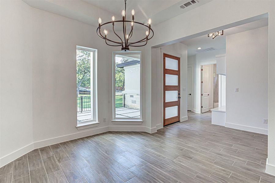 Formal dining area with chandelier. Formal dining area with chandelier.