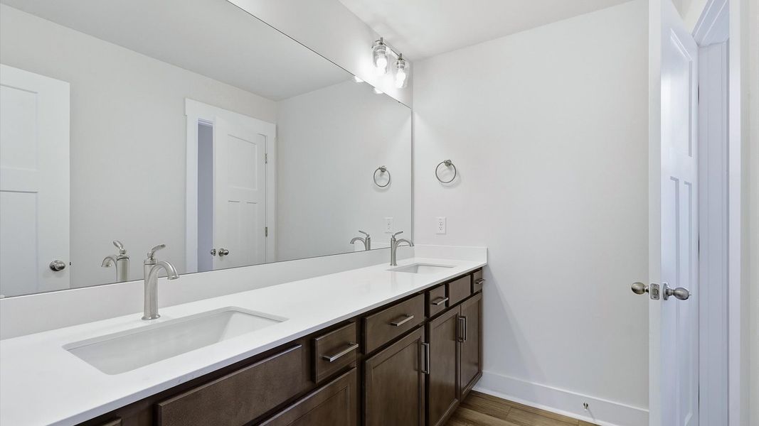 Accomplished bathroom design with sleek tile, high-quality cabinetry, and refined hardware at the Barton Hollow community Accomplished bathroom design with sleek tile, high-quality cabinetry, and refined hardware at the Barton Hollow community