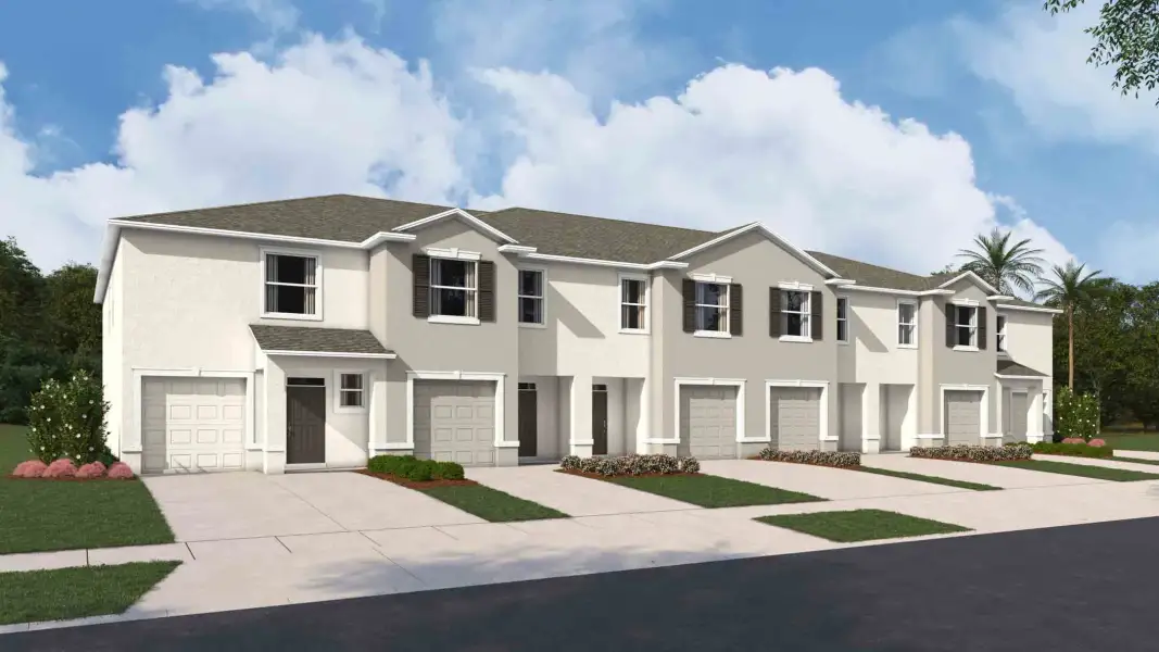 Front exterior of a new home in Towns at Woodsdale, Wesley Chapel, FL, highlighting curb appeal (Image 2).