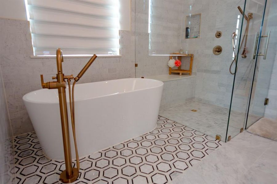 Full bath featuring a stall shower, tile walls, and a soaking tub Full bath featuring a stall shower, tile walls, and a soaking tub