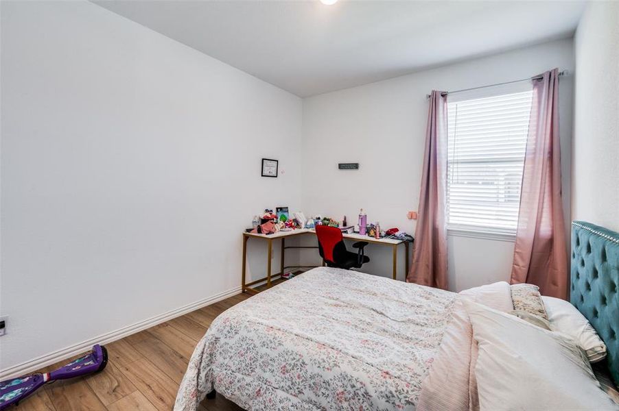 Bedroom with hardwood / wood-style floors