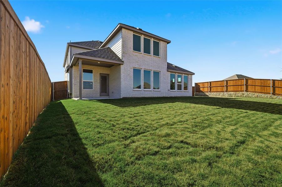 Rear view of property featuring a patio area, brick siding, a fenced backyard, and roof with shingles Rear view of property featuring a patio area, brick siding, a fenced backyard, and roof with shingles