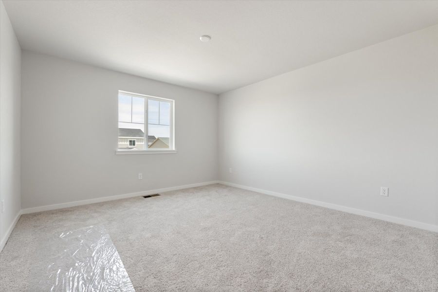 A room with a window and carpet. A room with a window and carpet.