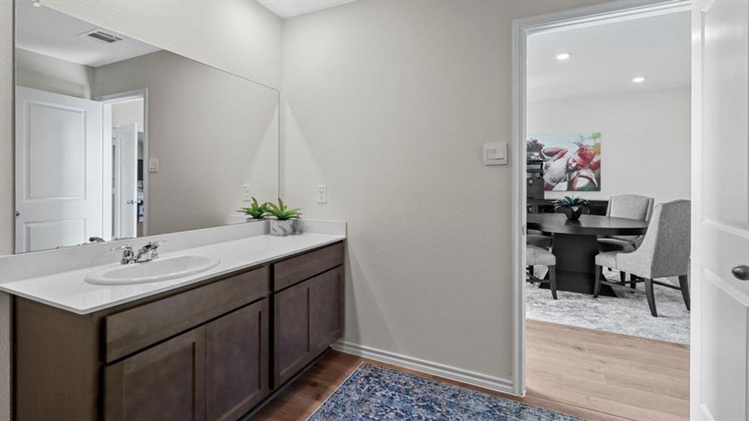 Bathroom featuring vanity, dark wood finished floors, and recessed lighting