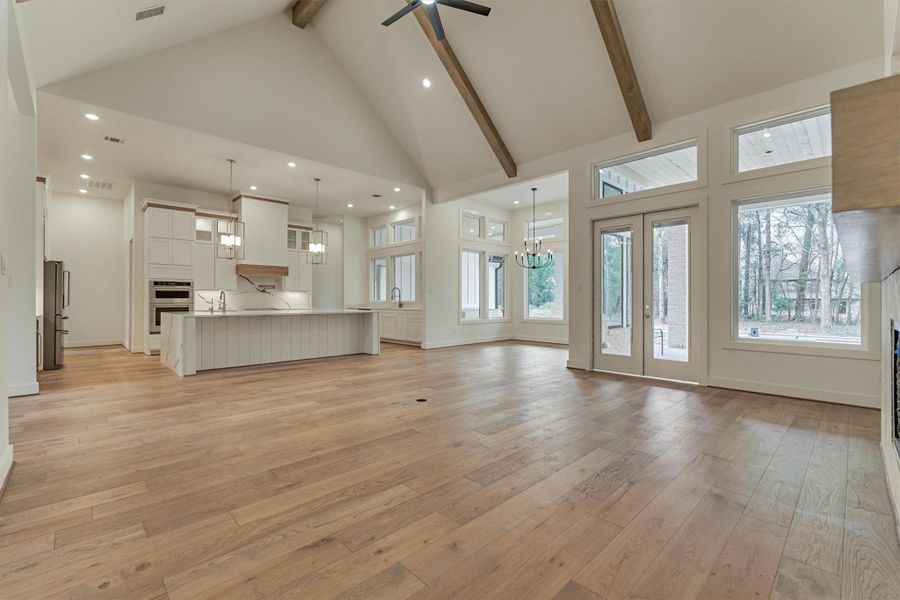 Open and airy layout featuring a chef’s kitchen, spacious dining nook, and expansive living area with vaulted ceilings and oversized windows for stunning natural light.