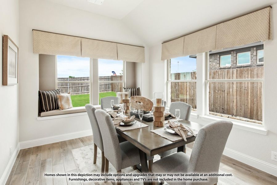Dining area with dark wood table, gray chairs, window seat, and large windows with backyard view