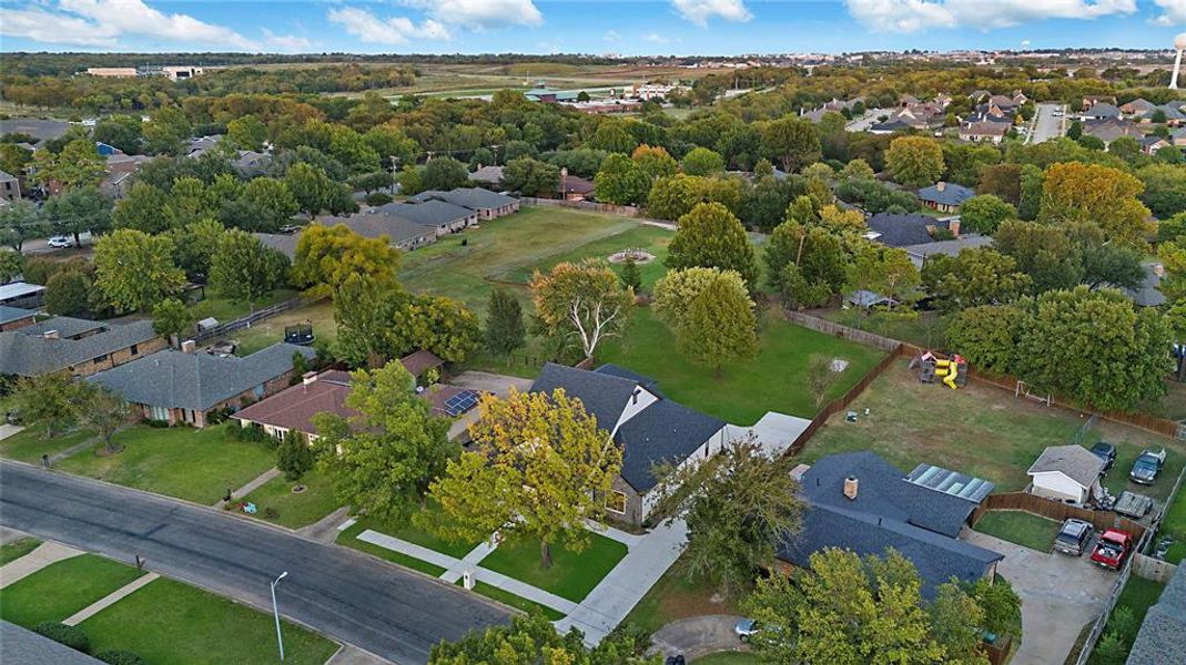 Aerial view of property's location with nearby suburban area