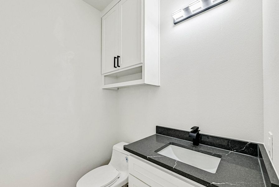 Bathroom featuring vanity and toilet