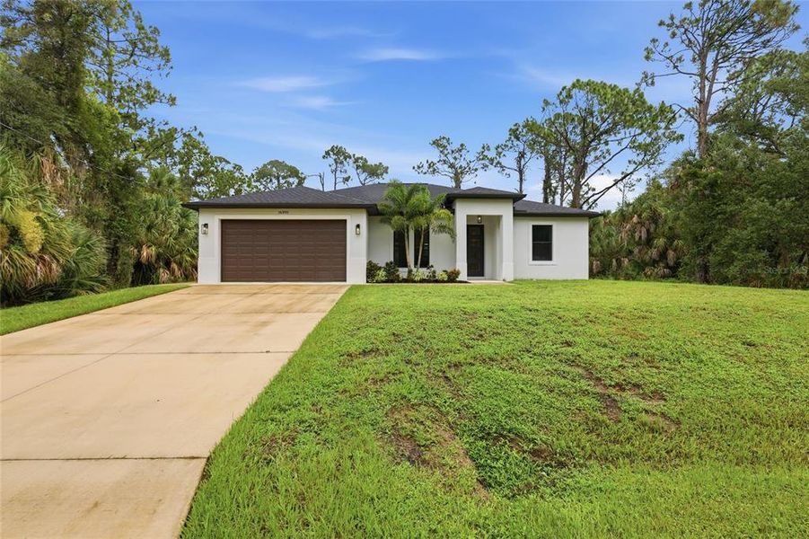 Front exterior of a new home in , Port Charlotte, FL, highlighting curb appeal (Image 24).