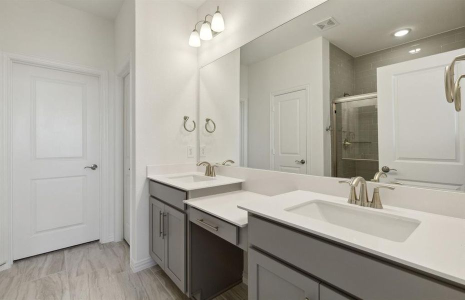 Spacious owner's bathroom with dual vanity and oversized shower*real home pictured