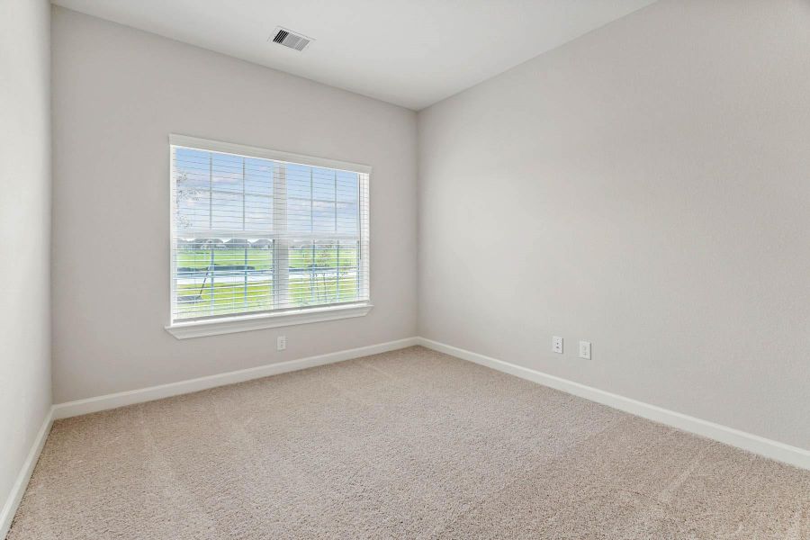 One of the two additional bedrooms in the home.