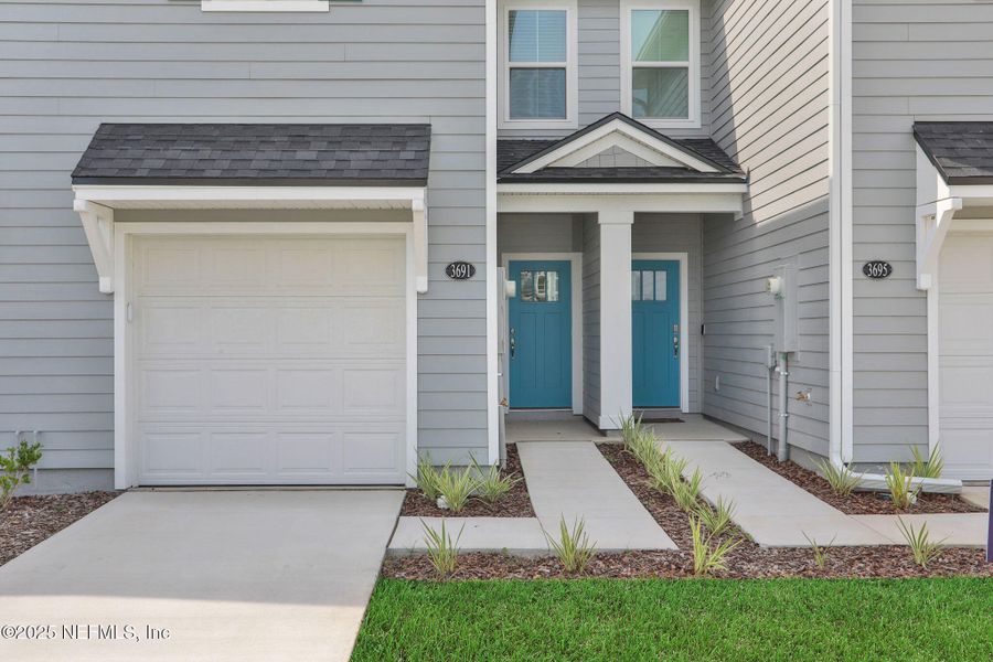 Front exterior of a new home in Atlantis Pointe, Middleburg, FL, highlighting curb appeal (Image 24).