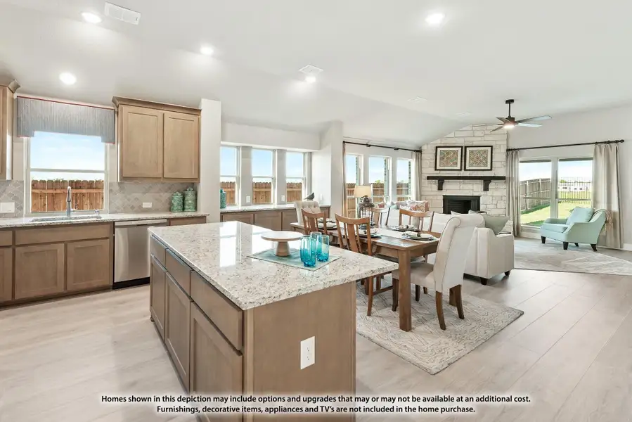 Open-concept kitchen with granite island flowing into dining area and living room with stone fireplace Open-concept kitchen with granite island flowing into dining area and living room with stone fireplace