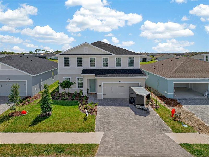 Front exterior of a new home in West Port Single Family Homes, Port Charlotte, FL, highlighting curb appeal (Image 20).