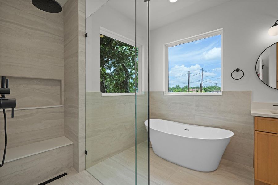 Luxurious bathroom retreat featuring a spacious walk-in shower and a freestanding soaking tub.